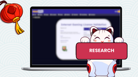 A laptop displaying a gambling license research page with a cat holding