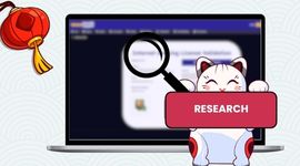 Maneki cat holding a research button with a magnifier icon.