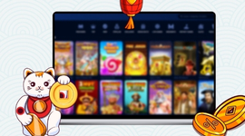 A Maneki-neko cat holding a gold coin in front of a laptop displaying casino games.