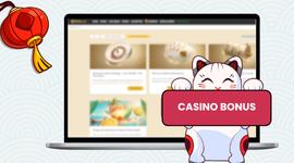 Casino bonus promotions displayed on a laptop screen with a lucky cat holding a sign.