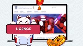 Cartoon cat in front of a laptop screen with licensed casinos, gold coins and red lantern decoration