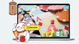 A lucky cat mascot and a laptop screen displaying a 