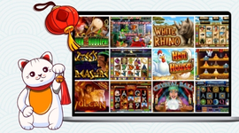 Maneki-neko cat next to a laptop screen displaying a grid of various online slot games.